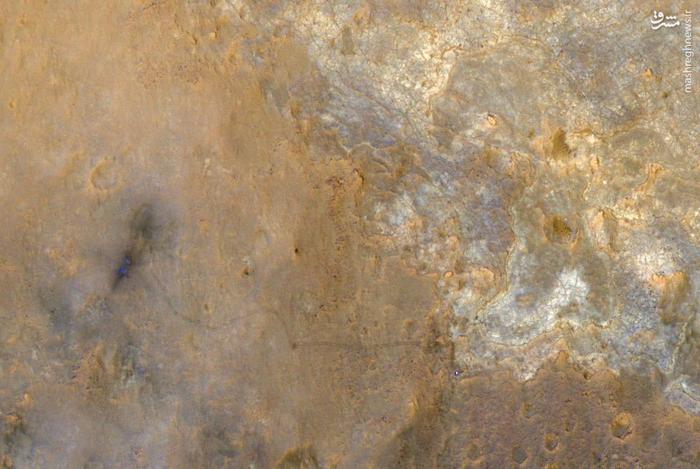 Curiosity appears as a bluish dot near the lower right corner of this enhanced-color view from Orbiter taken June 2013.