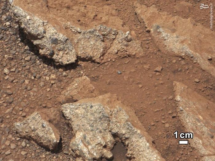 A rock outcrop called Link pops out from a Martian surface. Rounded gravel fragments, or clasts, up to a couple inches in size are in a matrix of white material. The outcrop characteristics are consistent with a sedimentary conglomerate, or a rock that was formed by the deposition of water and is composed of many smaller rounded rocks cemented together. Scientists enhanced the color in this version to show the Martian scene as it would appear under the lighting conditions we have on Earth.